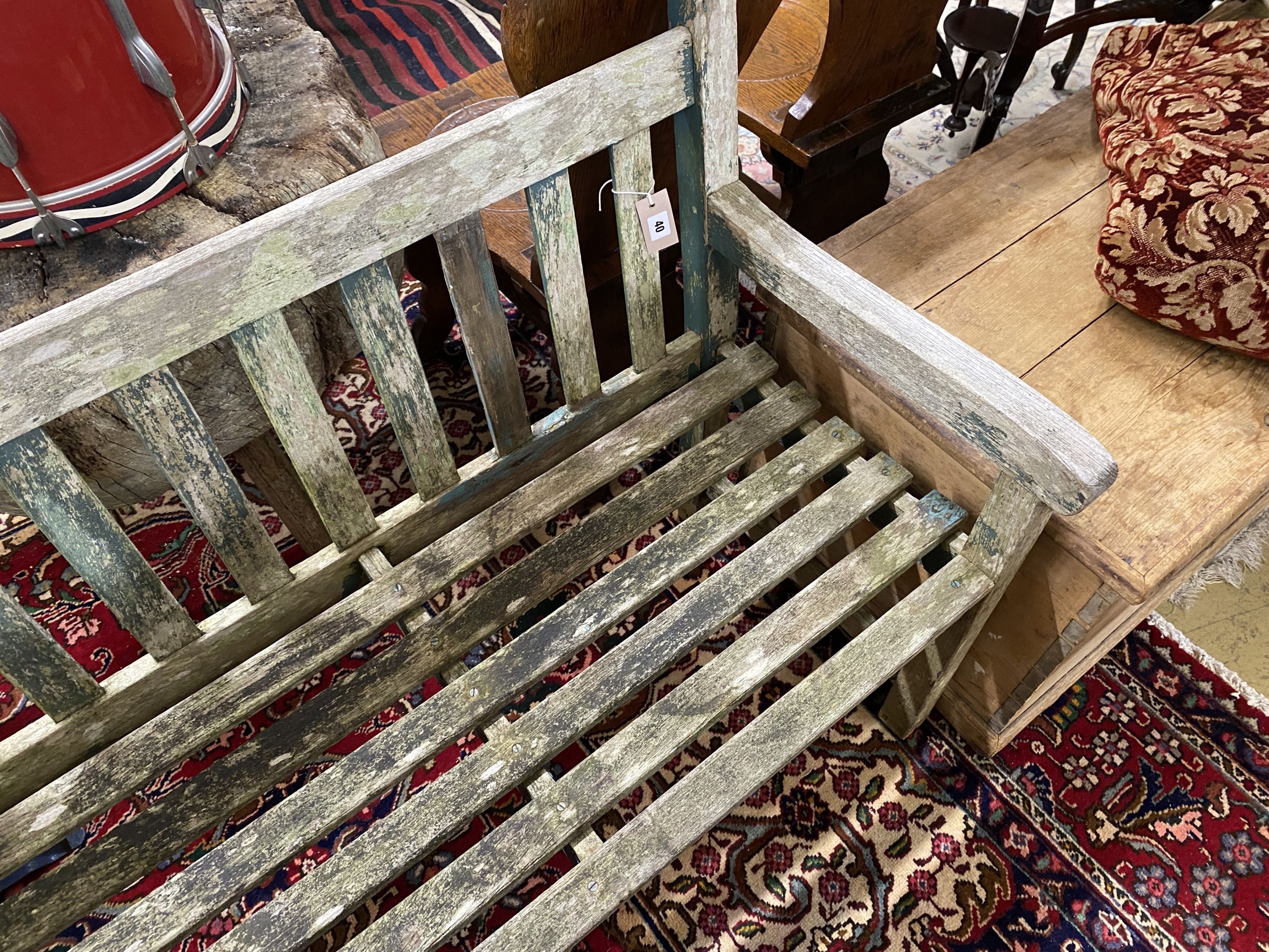 A weathered teak garden bench, length 153cm, depth 52cm, height 83cm